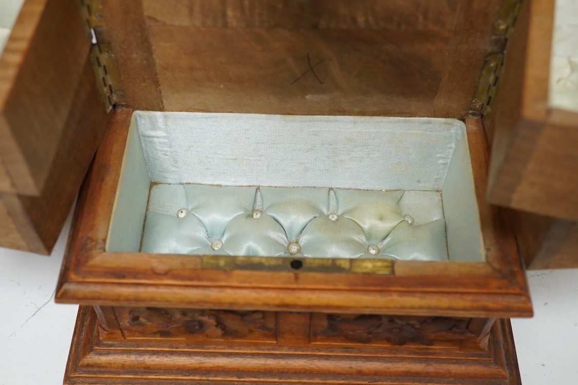 A 20th century black forest carved wood jewellery box, surmounted with two deer, 28cm high